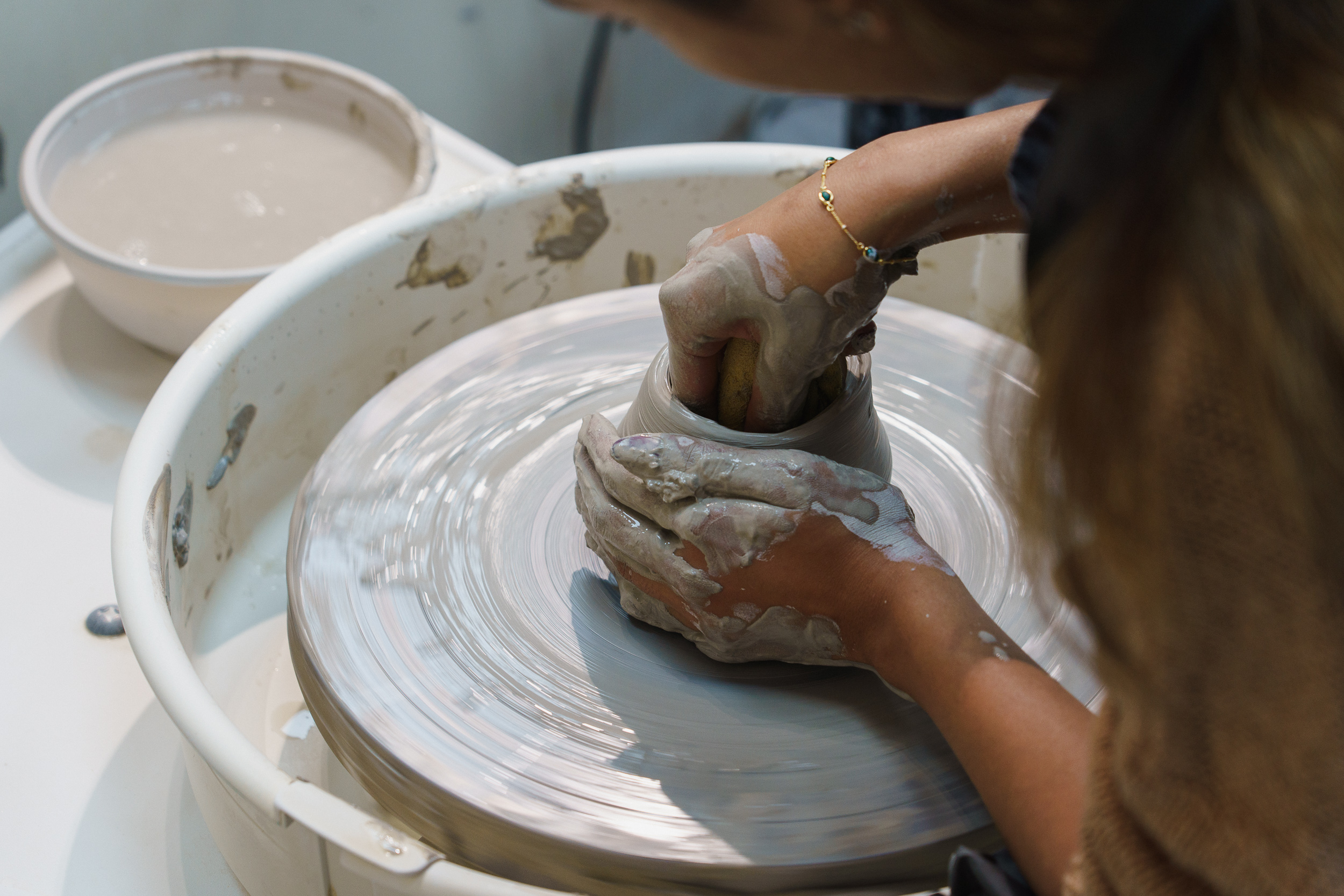 Pottery course at Putney School of Art & Design Pottery student shaping clay by hand in a PSAD studio
