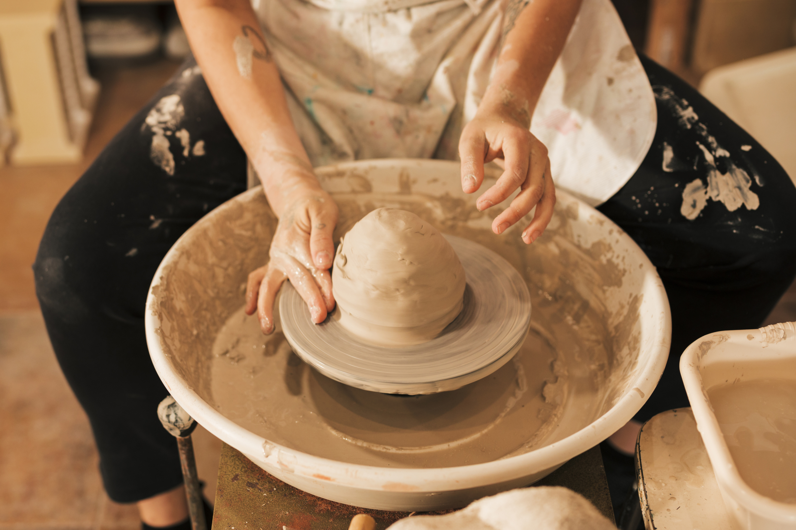 close-up-potter-s-hands-working-pottery-wheel