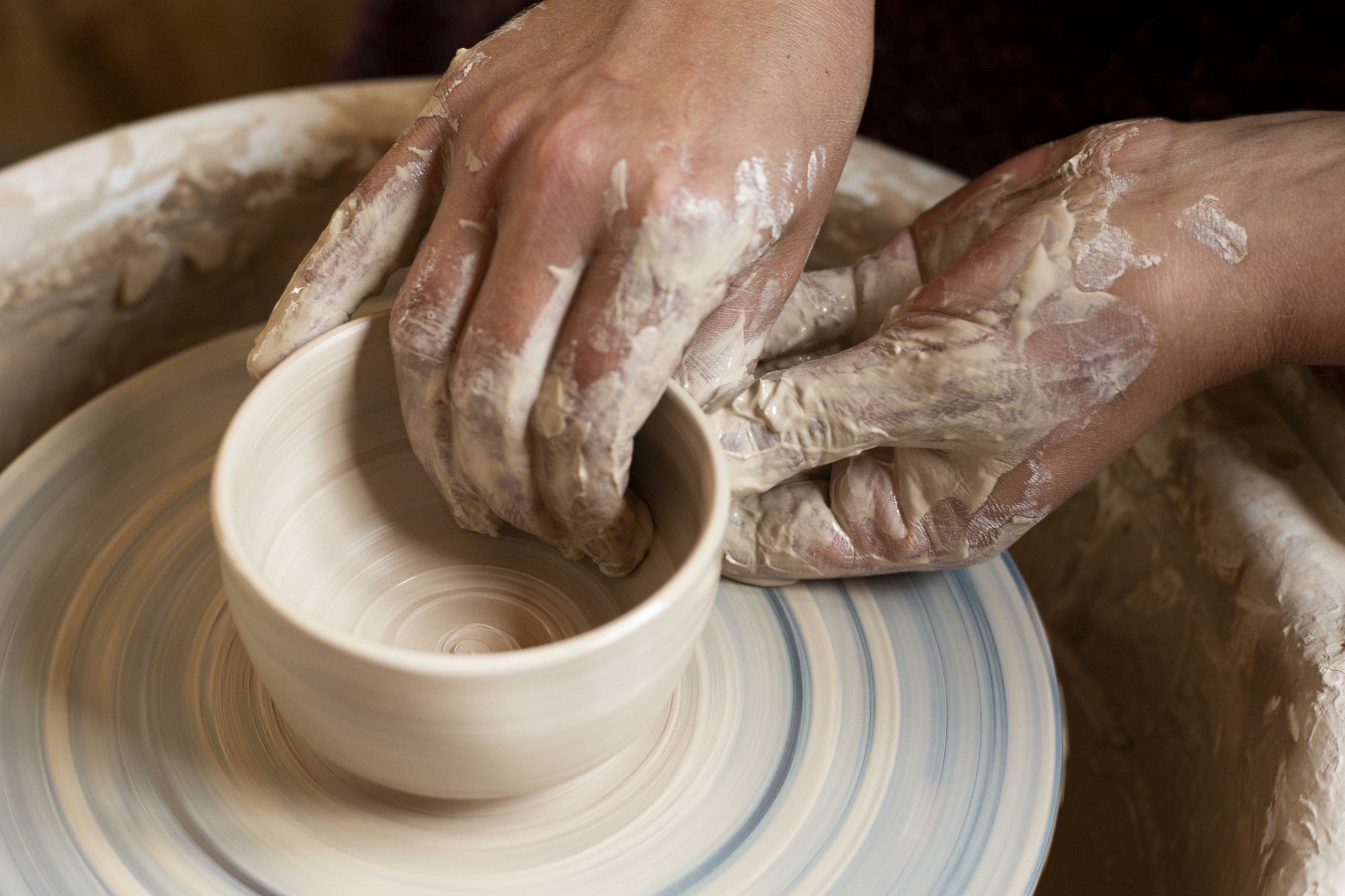 dirty-hands-modeling-clay-potter-s-wheel